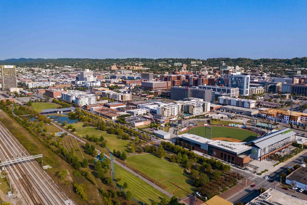 an aerial view of the city with the train tracks