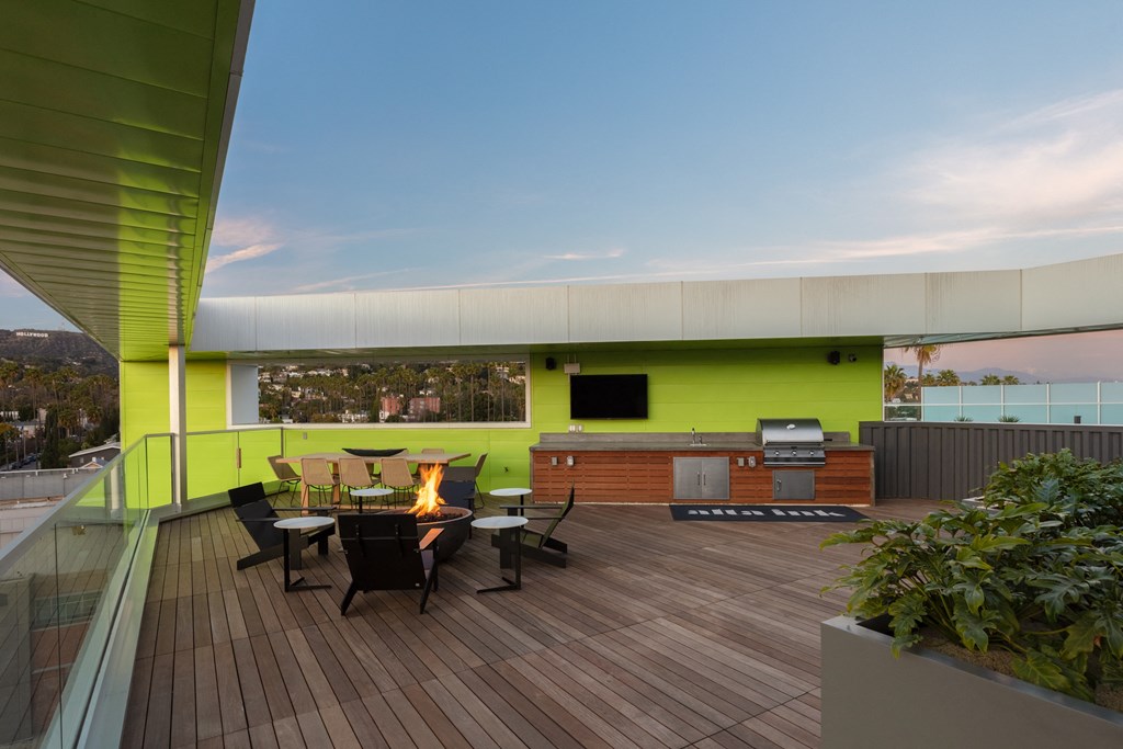 a large deck with a table and chairs and a fire pit