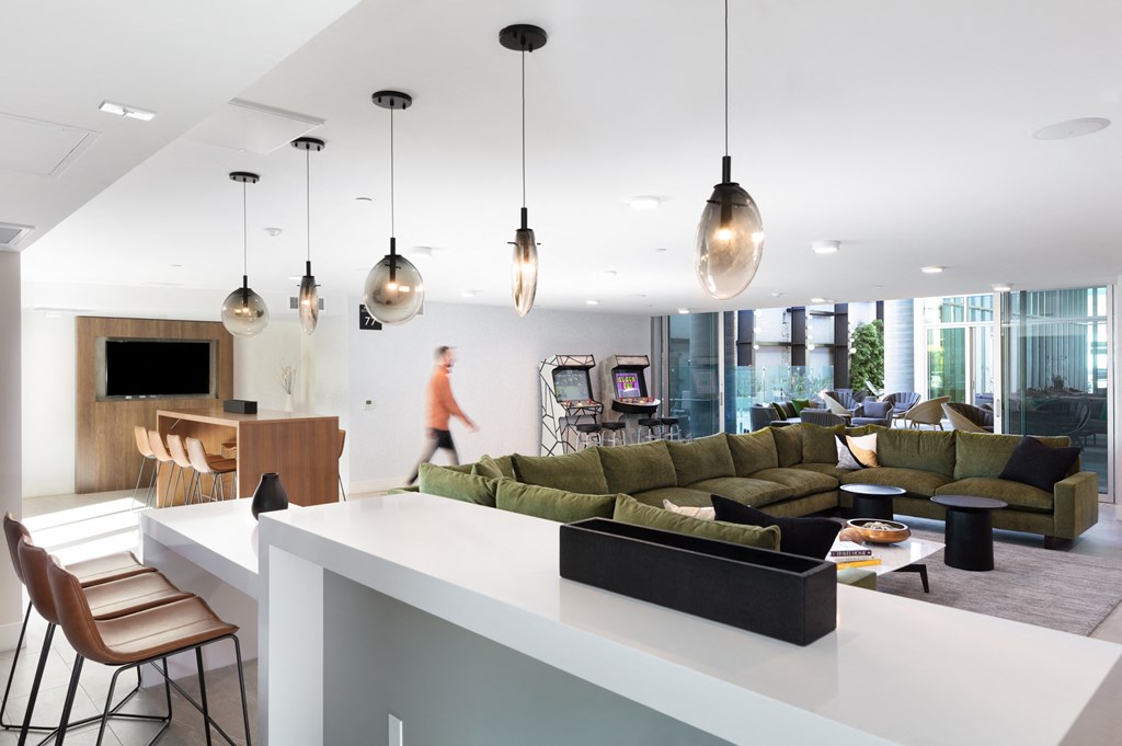 a large living room with couches and a kitchen