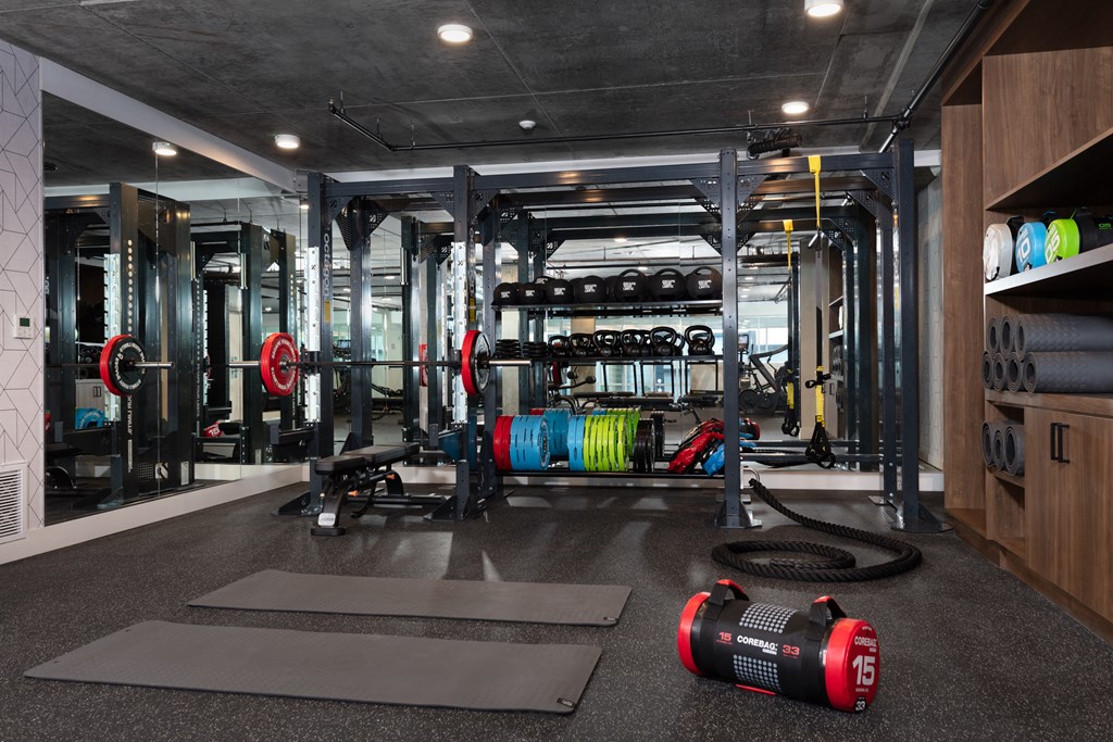 a gym with weights and other equipment on the floor