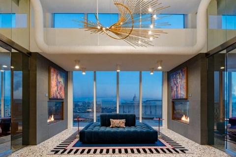 a living room with a blue couch and a large window