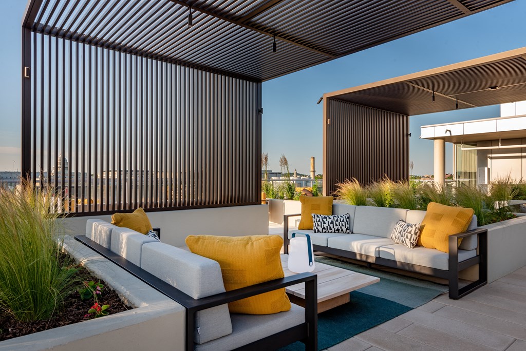 a patio with couches and a coffee table