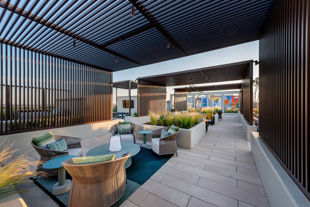 a rendering of a patio area with seating and plants