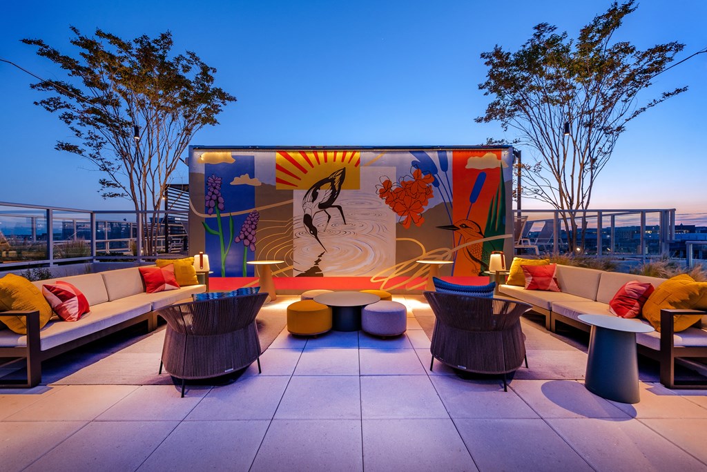 a rooftop lounge with couches and tables