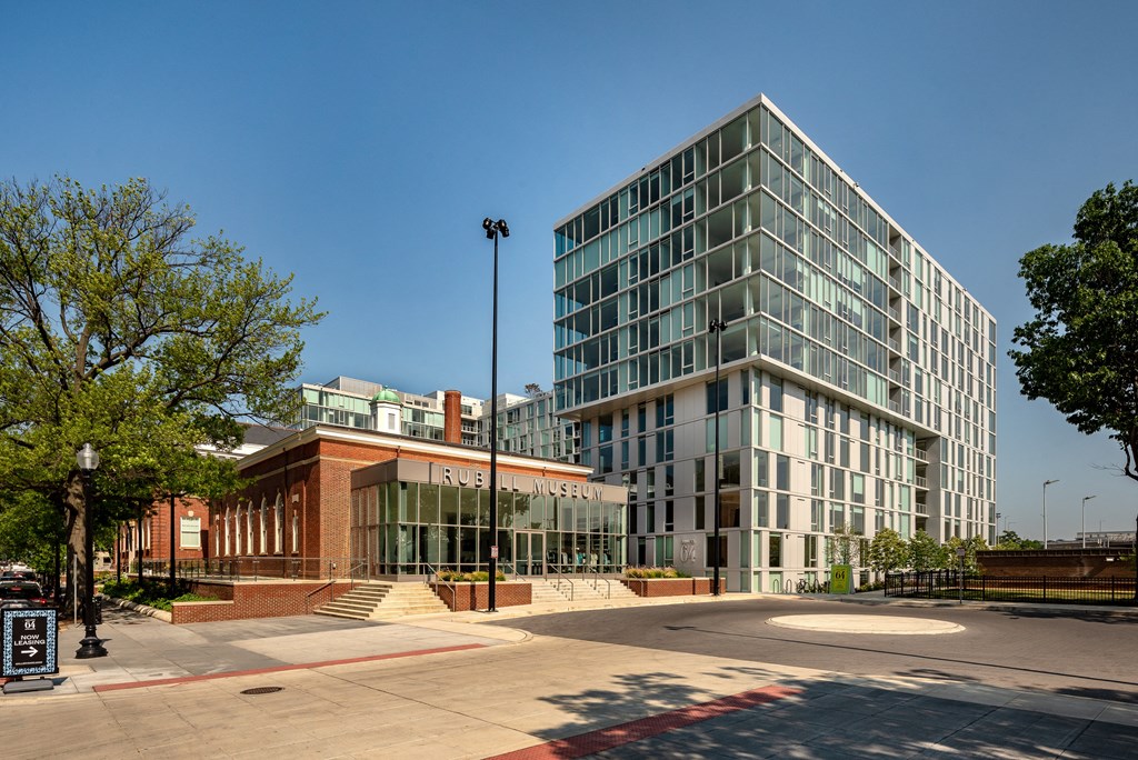 a large glass and brick building with a ramp in front of it