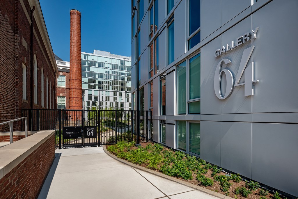 a walkway leading to a building with the number 64 on it