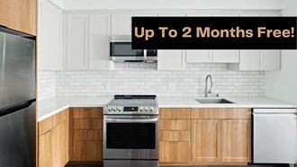 a kitchen with white cabinets and a black sign that says up to 2 months free