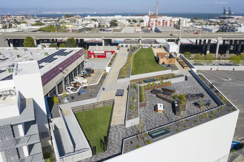 an aerial view of the roof of a building with grass