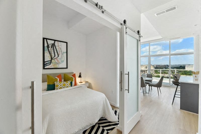 a bedroom with a bed and a window