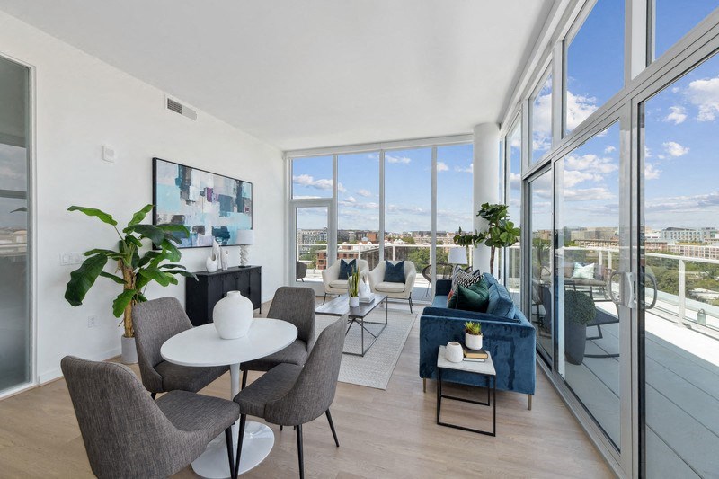 a living room with a large window and a view of a city
