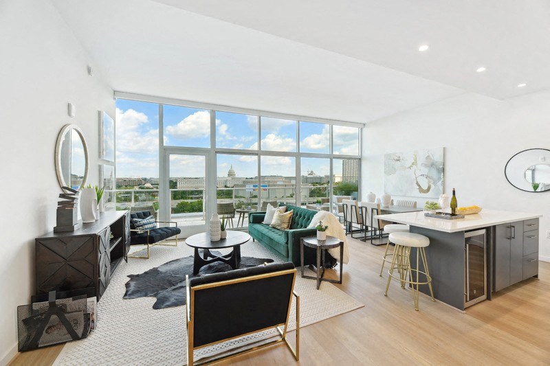 a living room with a large window and a view of a city