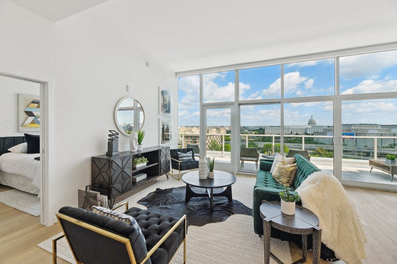 a living room with a large window and a view of the city