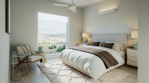 A bedroom with a large bed and a chair by the window.