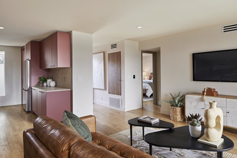 A living room with a brown leather couch and a black coffee table.