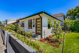 a small house with a garden in front of it