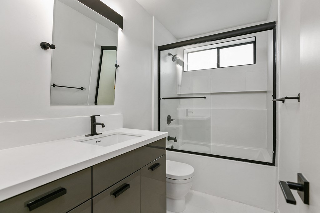 an empty bathroom with a toilet sink and shower