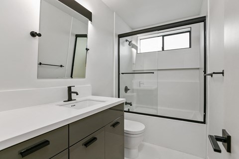 an empty bathroom with a toilet sink and shower