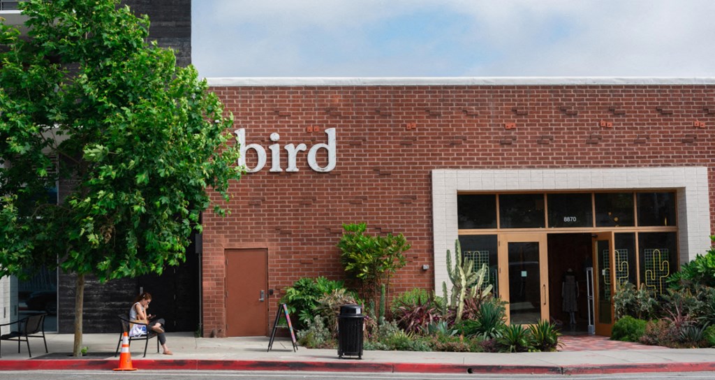 a brick building with a bird sign on the side