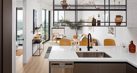 a kitchen and living room with a sink and a window