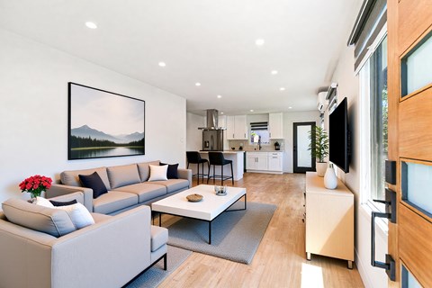 A modern living room with a grey sofa and a coffee table.
