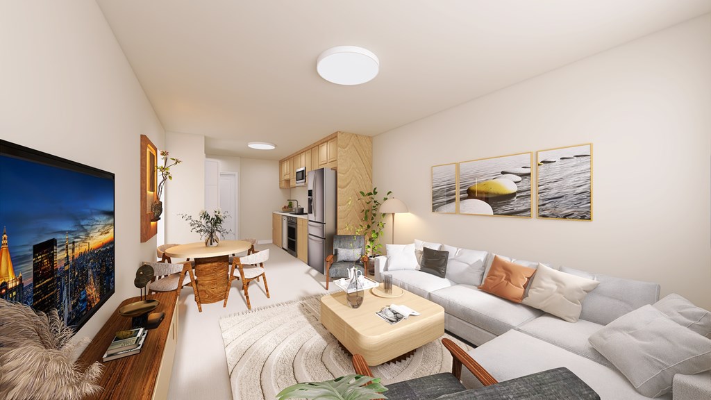 A modern living room with a large painting on the wall and a grey sofa.