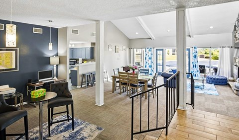 A living room with a black couch and a coffee table.