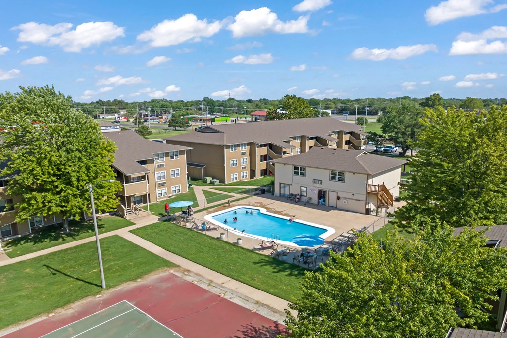 an aerial view of an apartment complex with a swimming pool