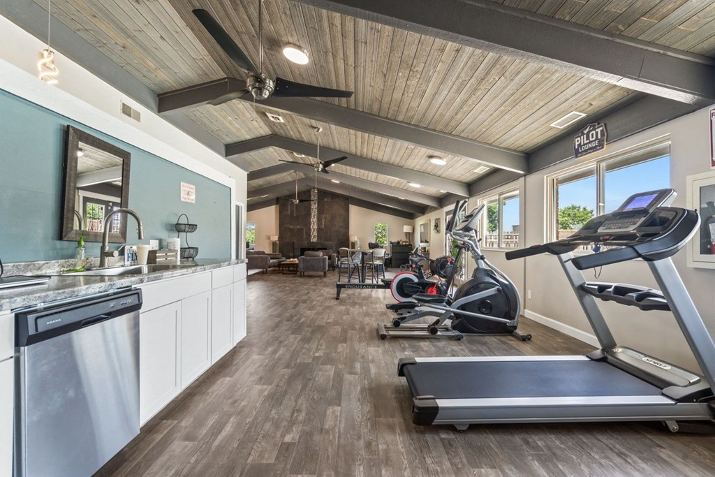the gym has plenty of cardio equipment and a kitchen