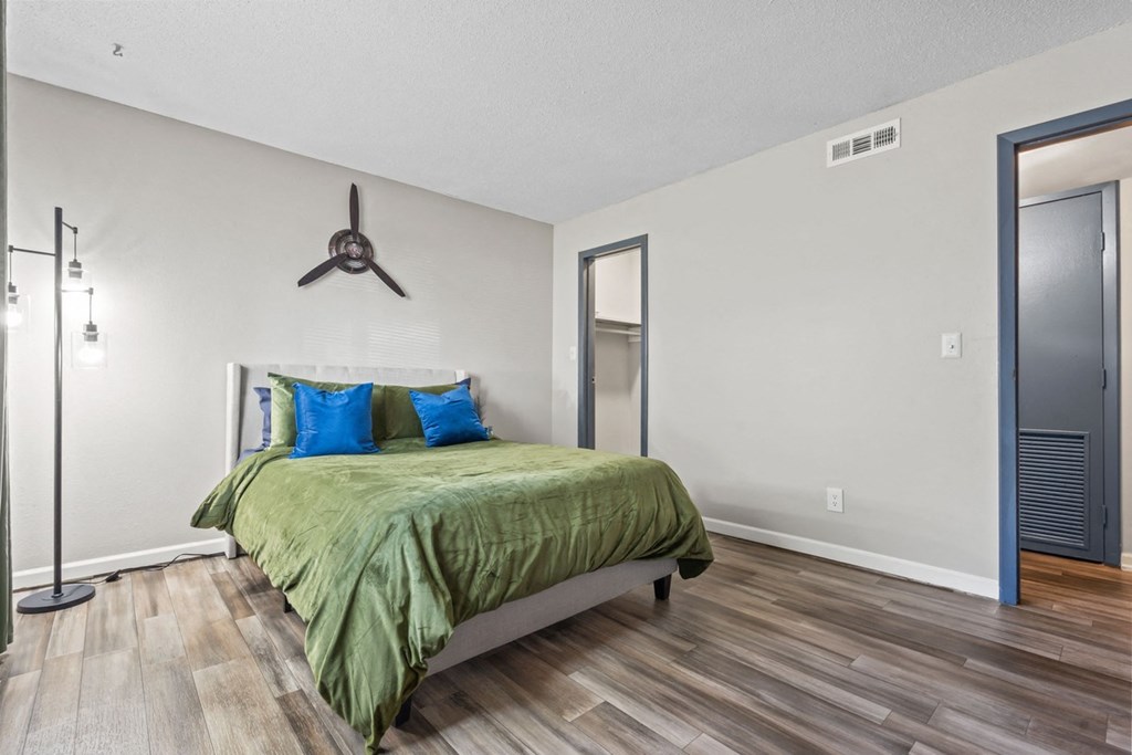 a bedroom with a bed and a ceiling fan