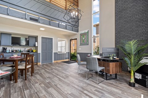 A modern open plan living and working space with a kitchen, dining table and a home office.