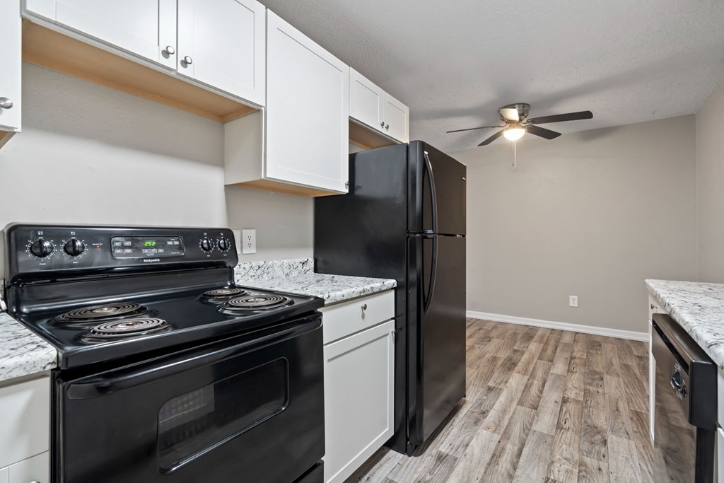 a kitchen with black appliances and a black refrigerator