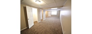 A room with carpeted floor and white walls.