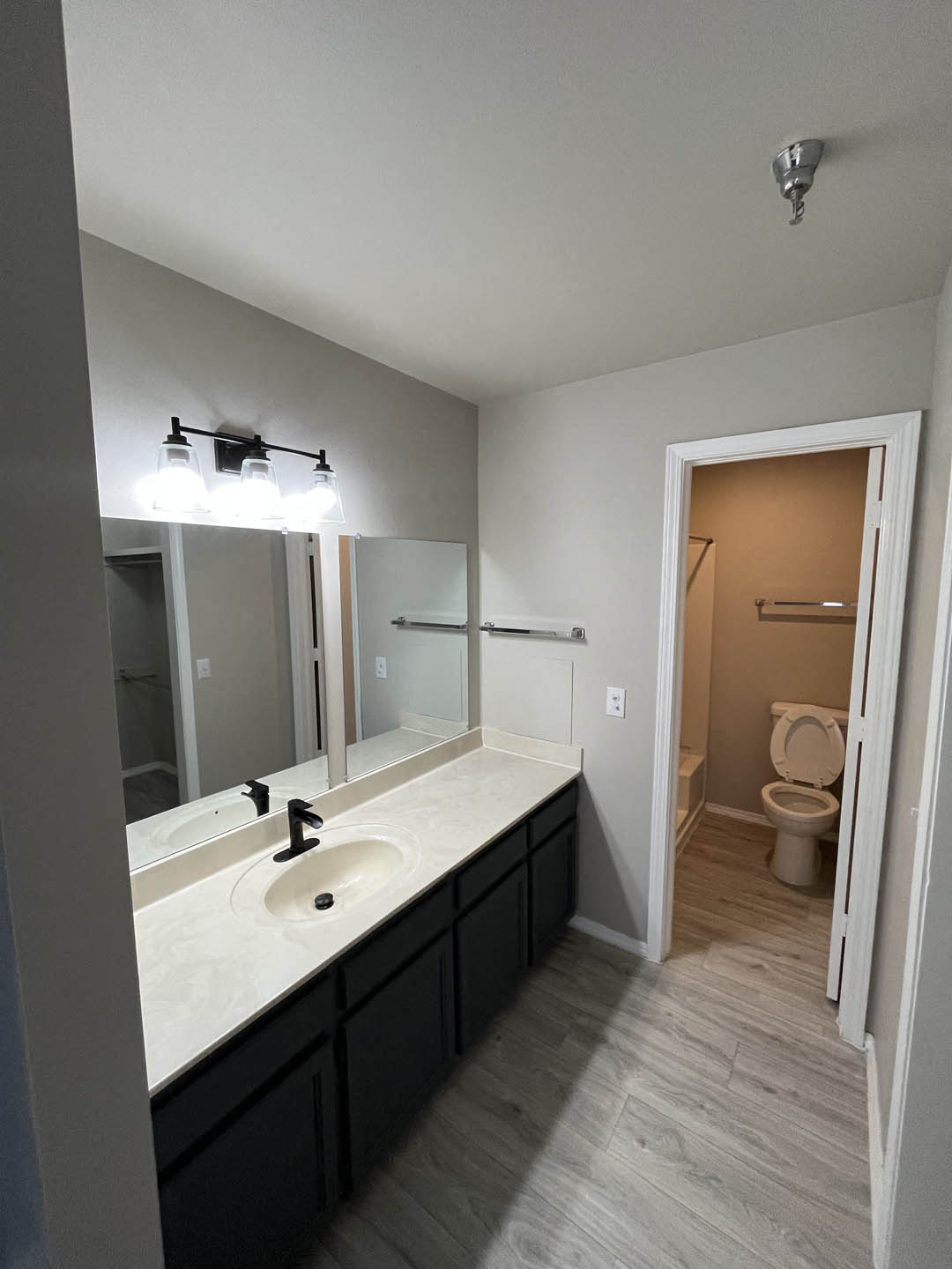 a bathroom with a sink and a toilet at The Lodge Apartments, Tulsa