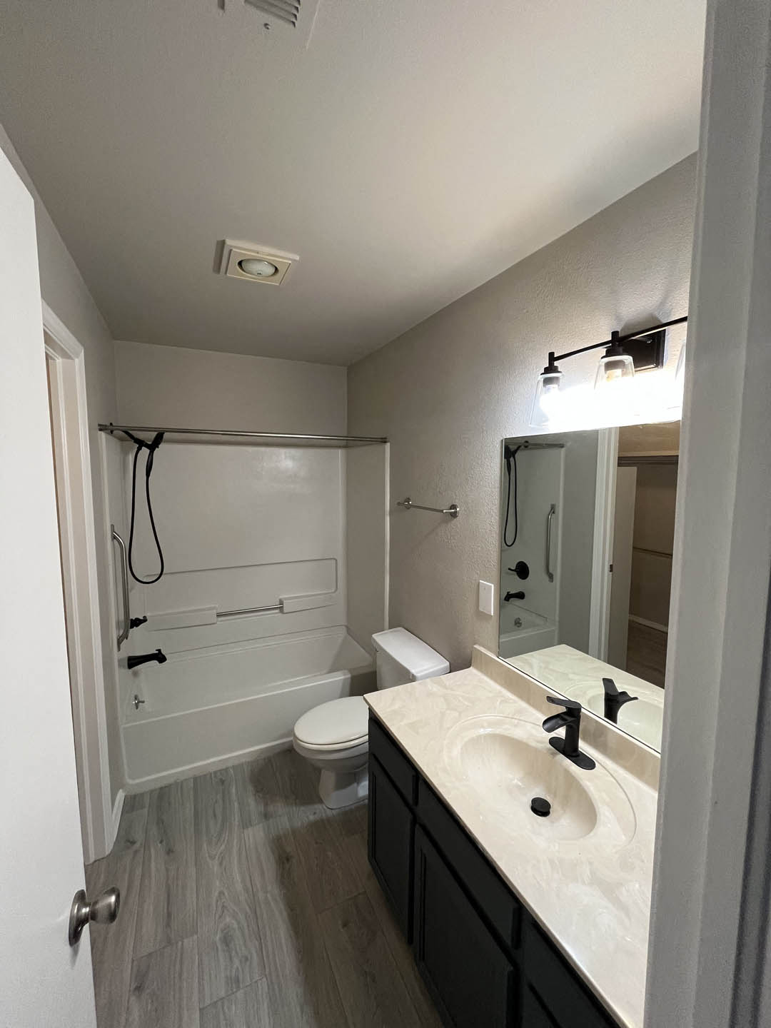 a bathroom with a sink toilet and shower at The Lodge Apartments, Tulsa, 74129