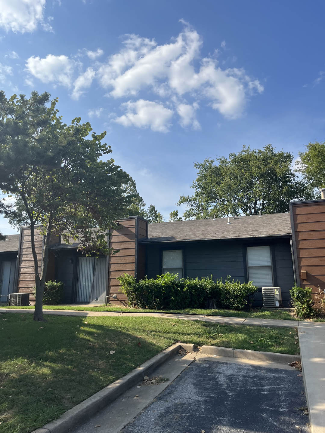 a picture of a house with a blue sky in the background at The Lodge Apartments, Tulsa, OK 74129