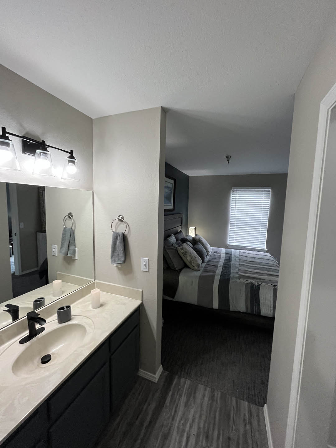 a bathroom with a sink and a mirror at The Lodge Apartments, Tulsa