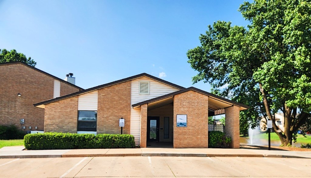 A small building with a brick facade and a sign on the door.