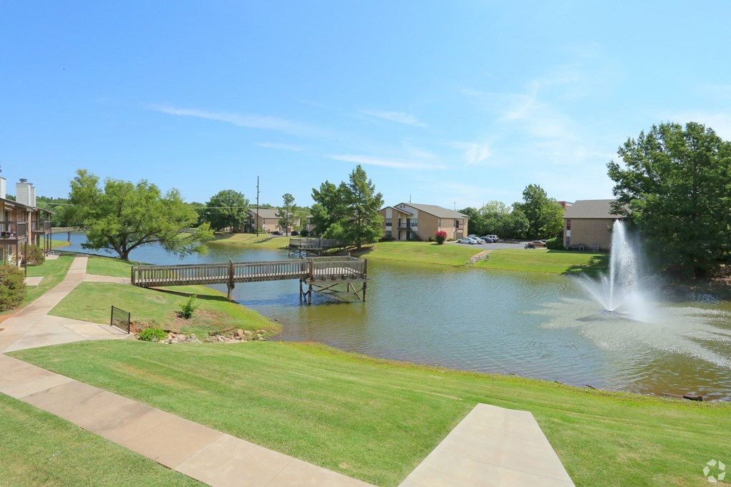 A park with a pond and a fountain.