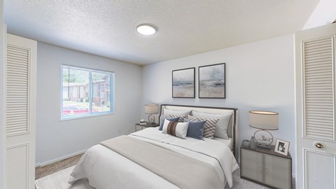 A bedroom with a large bed and a window overlooking a street.