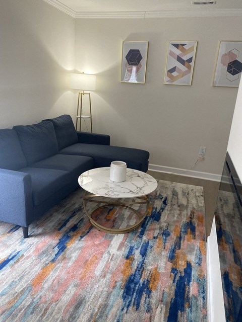 a living room with a blue couch and a coffee table