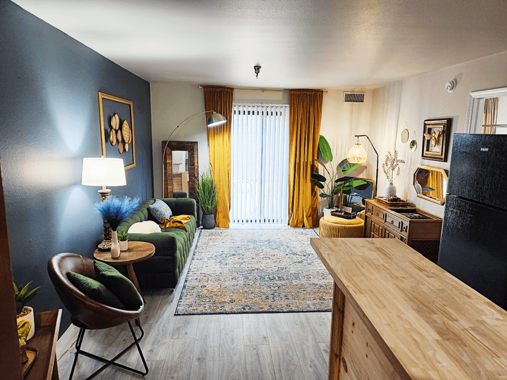 a living room with a couch and a table at The Lodge Apartments, Tulsa, OK 74129
