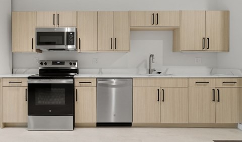 A modern kitchen with wooden cabinets and stainless steel appliances.