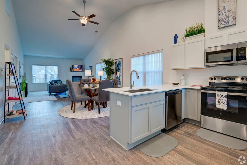 A kitchen with a dining table and chairs.