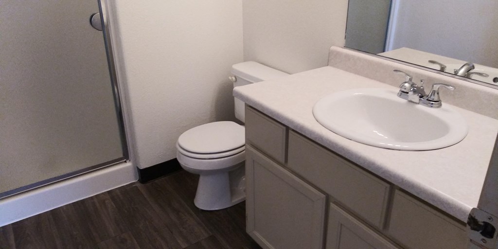 an image of a bathroom with a sink toilet and shower