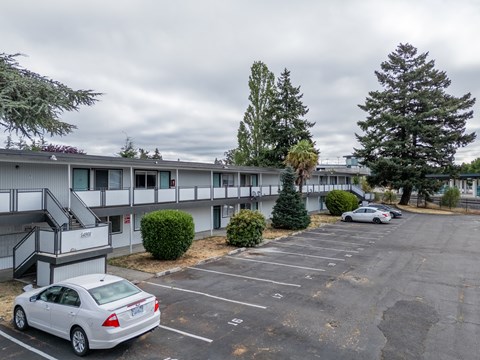 A parking lot with a white car parked in the foreground.