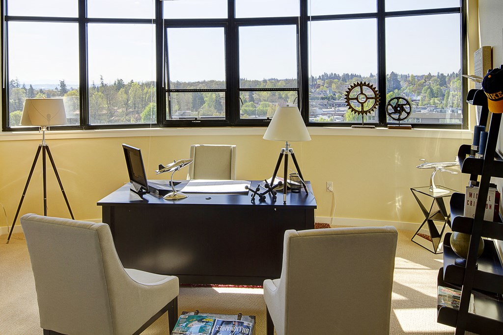 a desk and chairs in a room with a window