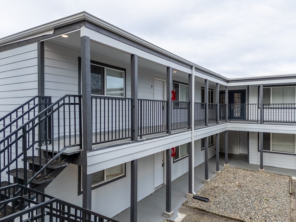 A multi-level residential building with a staircase and railings.