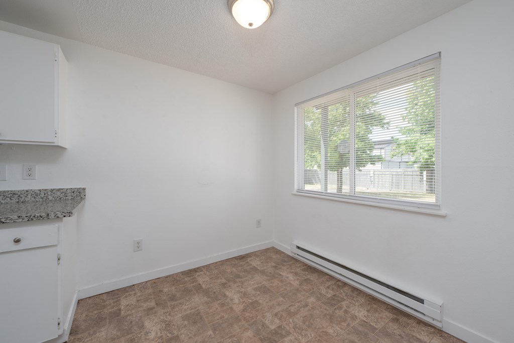 A room with a window and a counter top.