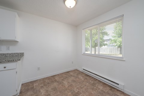 A room with a window and a counter top.