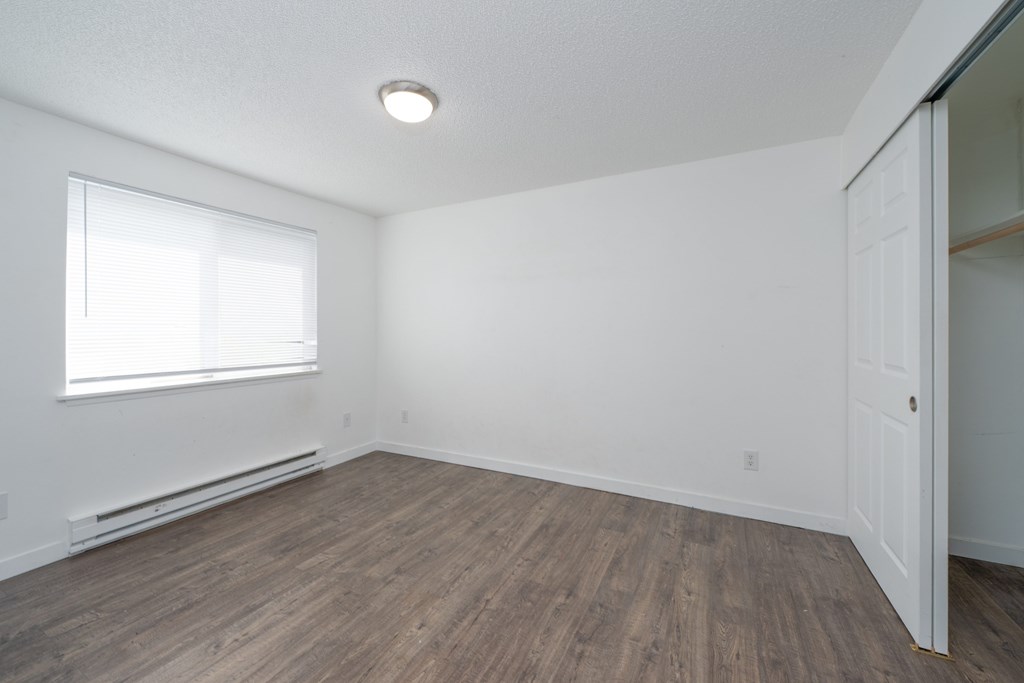 A room with a window and a door.